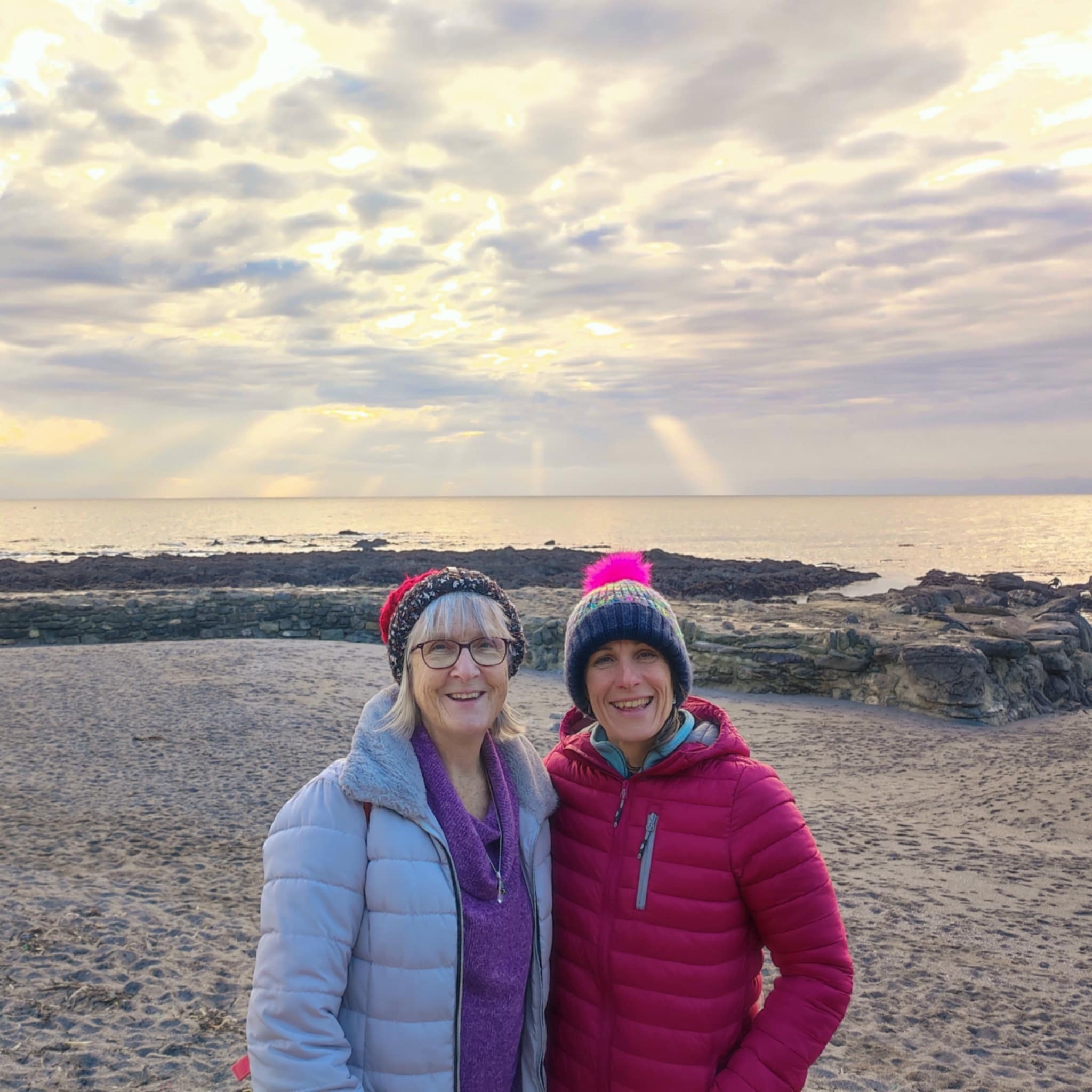 Lisa and her mum together on the beach, smiling